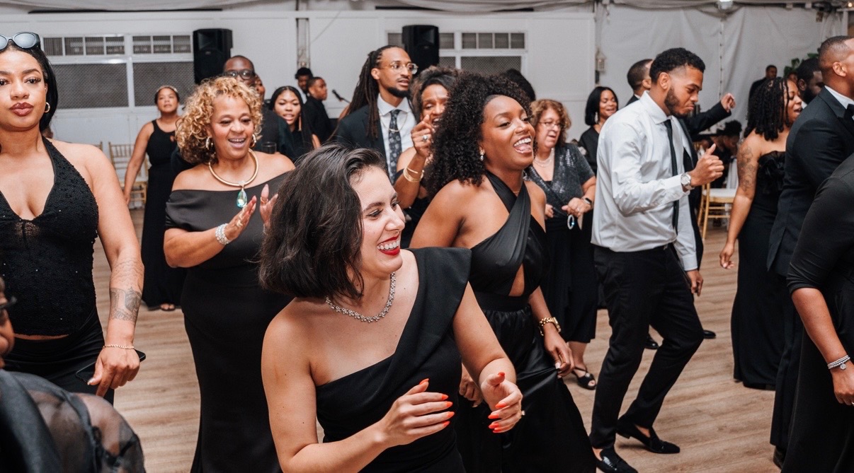 Wedding guests laughing and dancing together at a Maryland reception