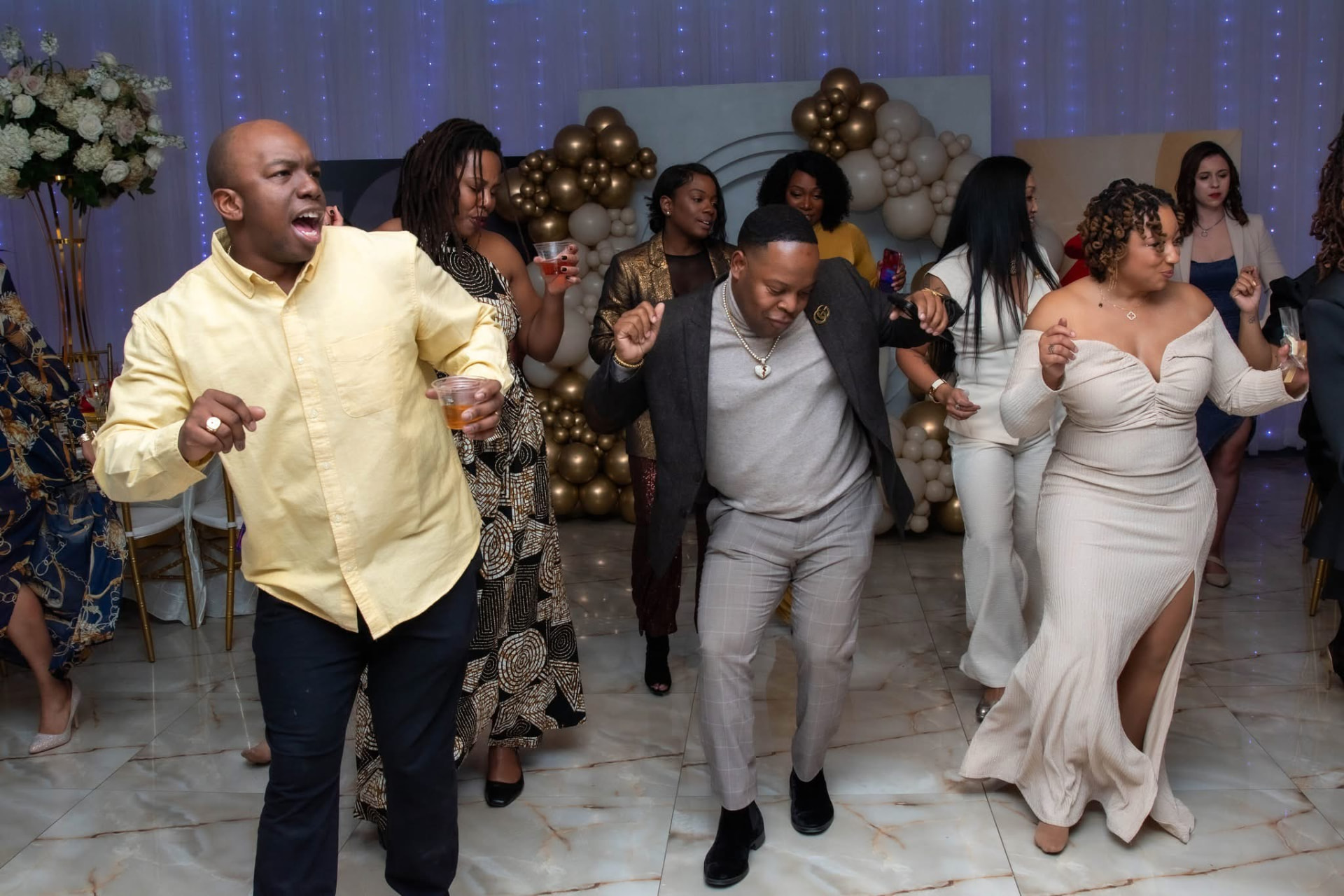 Wedding guests celebrating together on the dance floor at an elegant reception